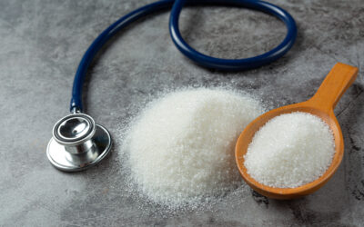 World diabetes day; sugar in wooden bowl and stethoscope on dark