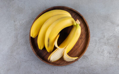 Bunch of juicy yellow banana placed on a stone background